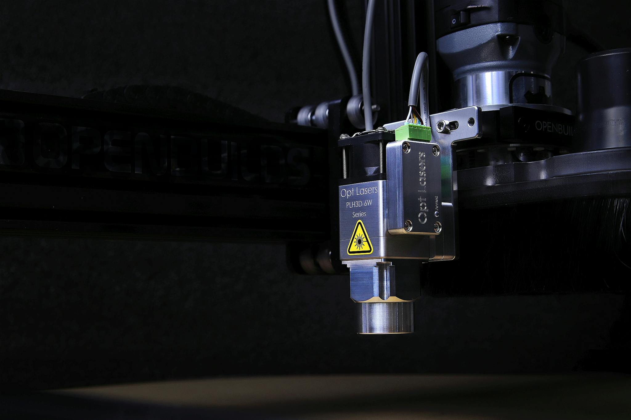 Detailed view of an Opt Lasers engraving machine in operation, showcasing precision technology.